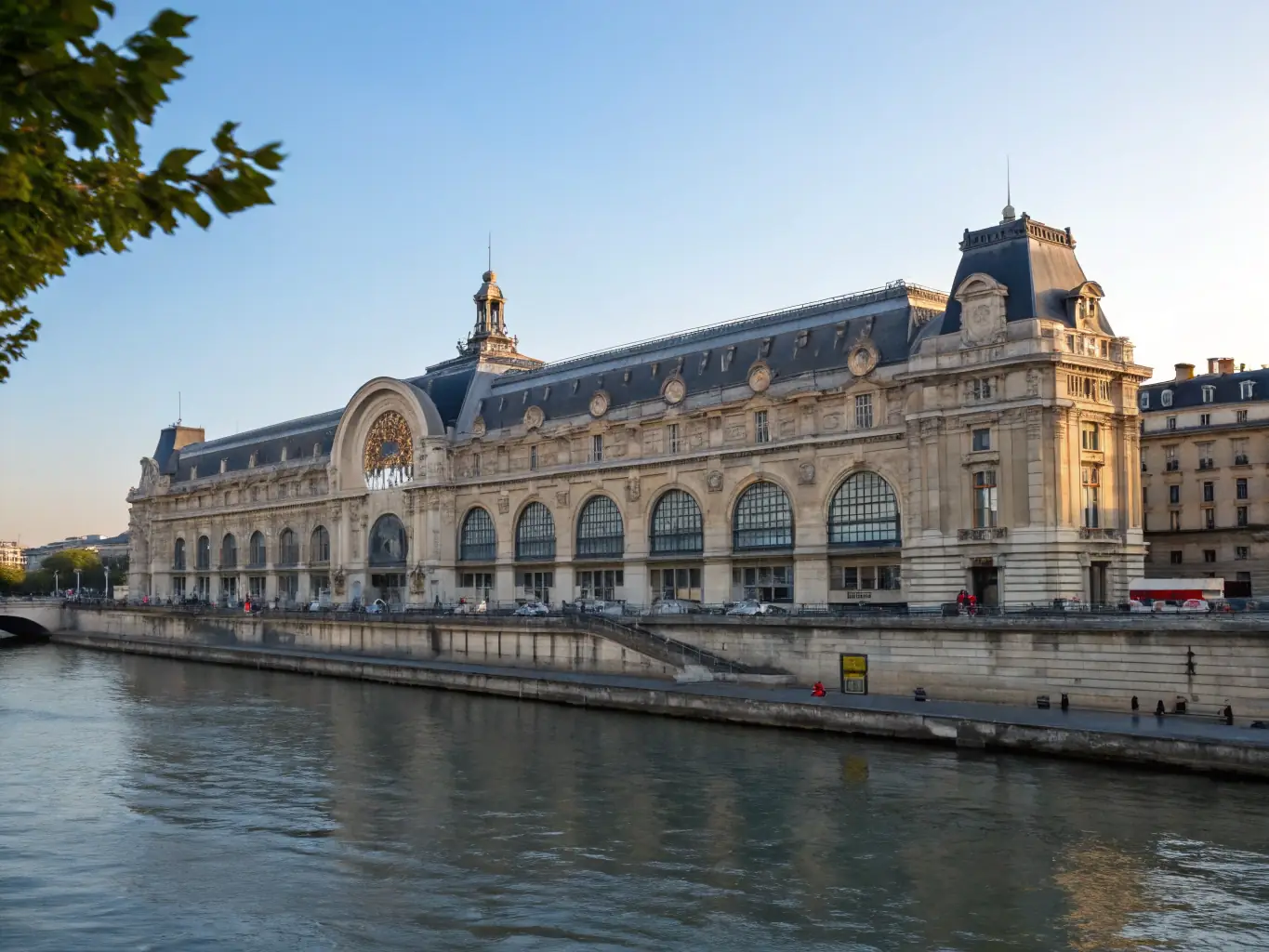 A vibrant photograph of the Musée d'Orsay, showcasing its stunning architecture and the Seine River in the background, capturing the essence of Impressionist art.